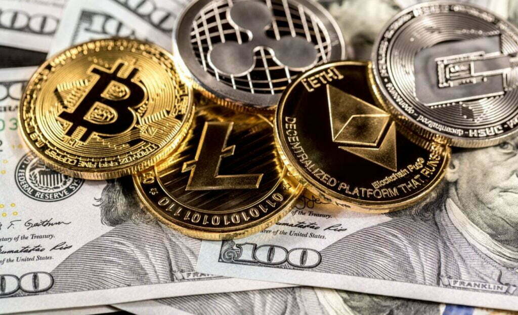 Silver and golden coins with bitcoin, ripple and ethereum symbol