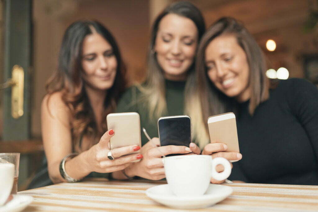 Friends watching social media in a smart phone.