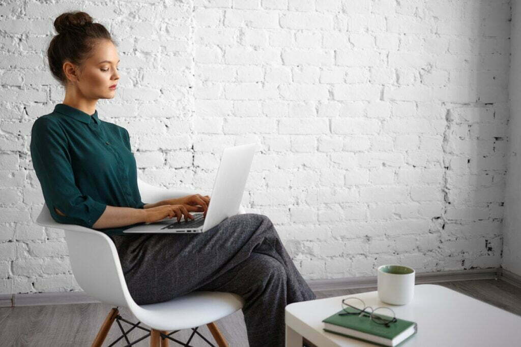 people-lifestyle-leisure-technology-communication-concept-fashionable-young-female-blogger-working-remotely-using-wifi-portable-computer-her-lap-typing-fast-having-morning-coffee