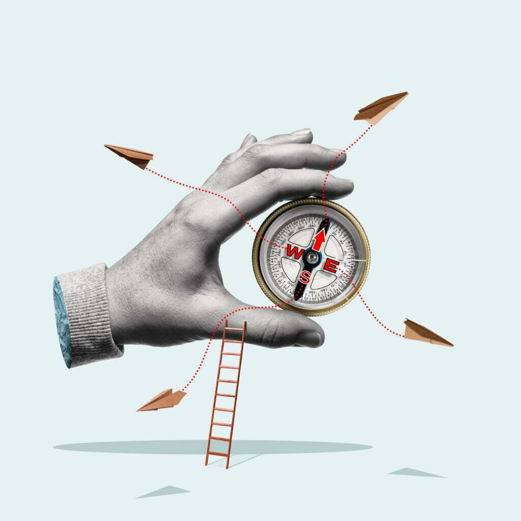 Compass,In,A,Man's,Hand.,Business,Development,In,Different,Directions.