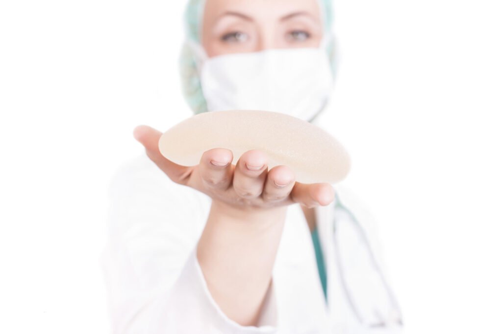 shallow-focus-shot-female-plastic-surgeon-holding-breast-implant