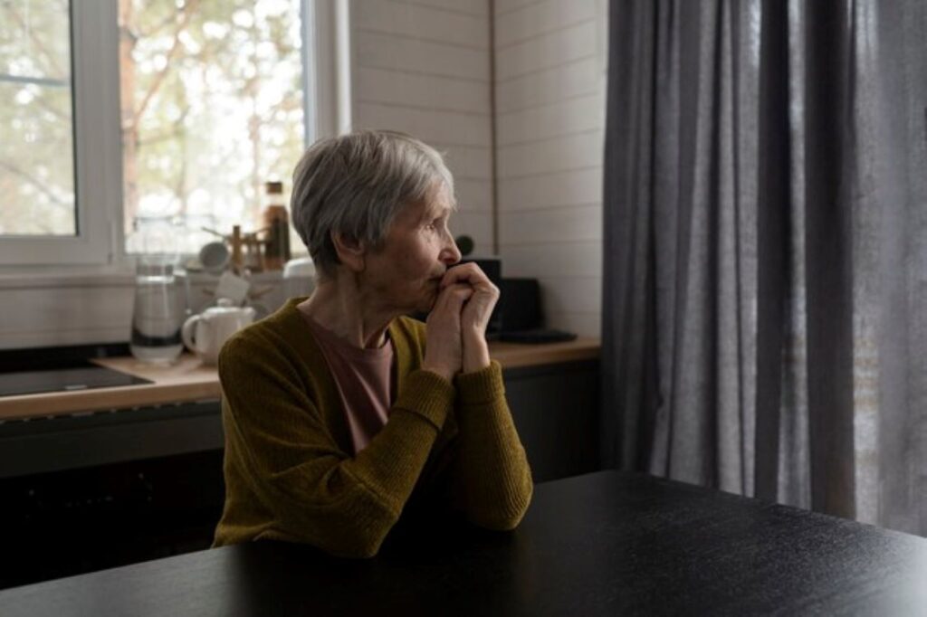 medium-shot-senior-woman-sitting-table_23-2149390042