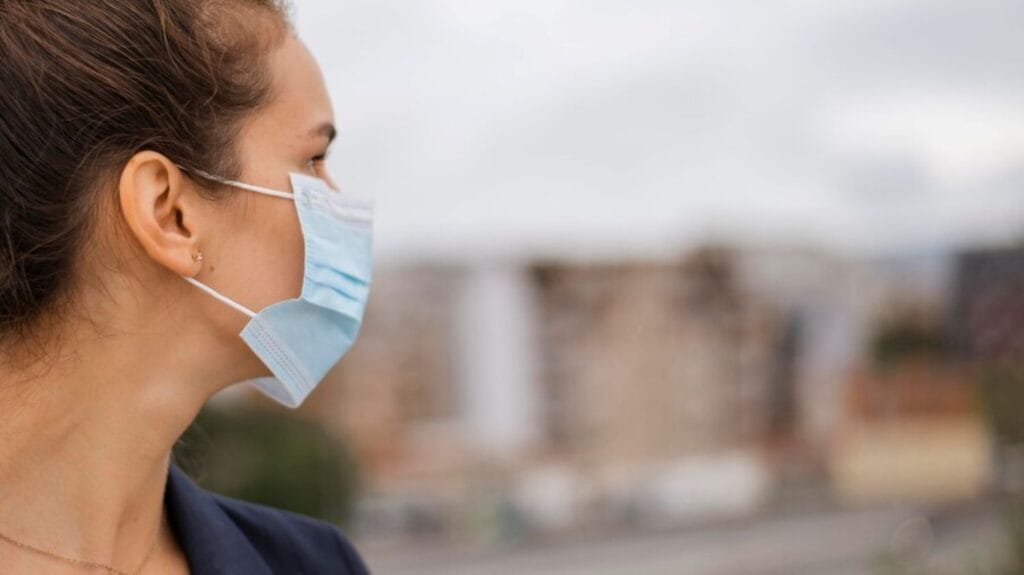 sideways-woman-with-medical-mask-with-copy-space_23-2148767521